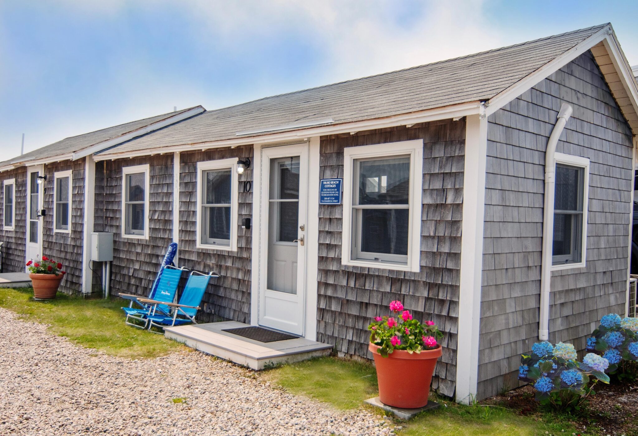 A shingled beach cottage with white trim.